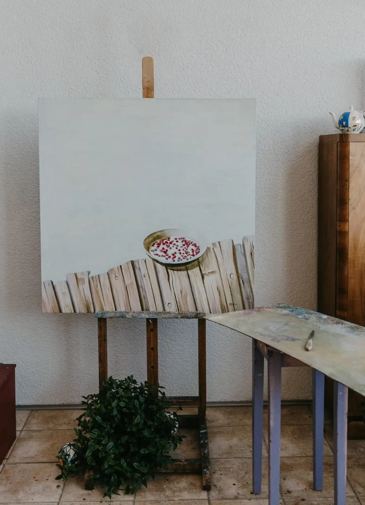 painting of bowl of strawberies in milk on a canvas